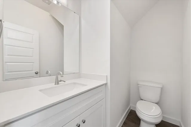 a bathroom with a sink toilet and vanity