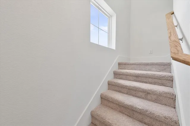 a view of staircase with white walls