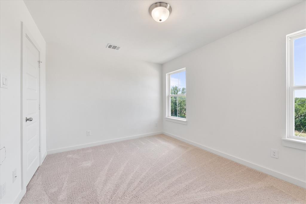 1210 Chestnut Court, Unit 1 Runaway Bay, TX 76426 - Photo 20 of 29 an empty room with windows