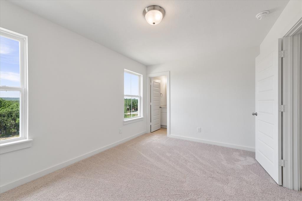 1210 Chestnut Court, Unit 1 Runaway Bay, TX 76426 - Photo 21 of 29 an empty room with windows