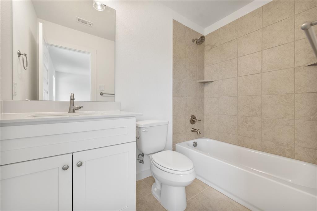 1210 Chestnut Court, Unit 1 Runaway Bay, TX 76426 - Photo 22 of 29 a bathroom with a bathtub shower sink vanity and toilet