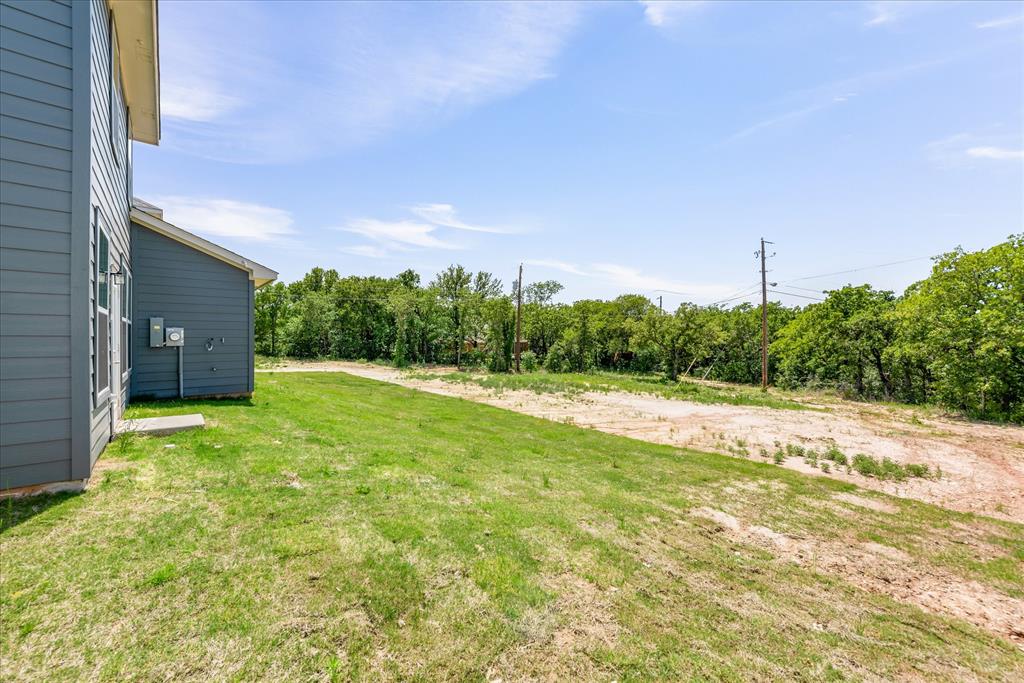 1210 Chestnut Court, Unit 1 Runaway Bay, TX 76426 - Photo 27 of 29 a view of a yard with an outdoor space
