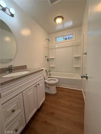 a bathroom with a double vanity sink mirror and toilet
