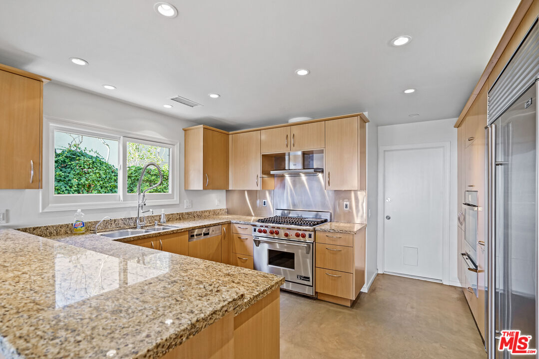 3444 Cloudcroft Drive Malibu, CA 90265 - Photo 13 of 50 a kitchen with a stove a sink and a refrigerator