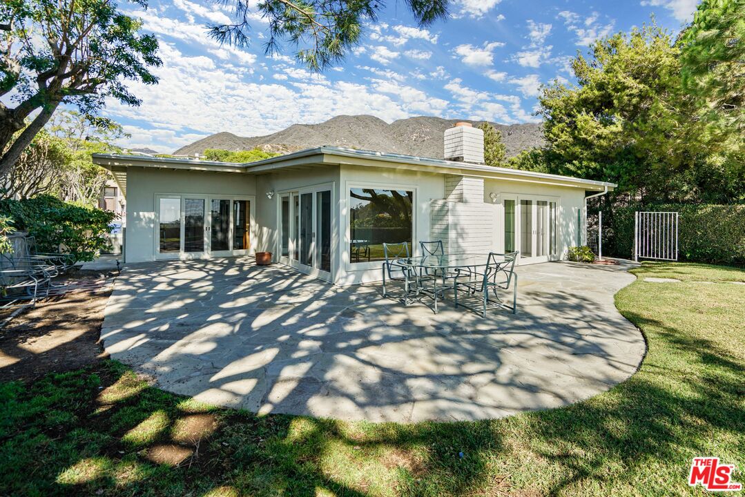 3444 Cloudcroft Drive Malibu, CA 90265 - Photo 19 of 50 a front view of a house with a yard