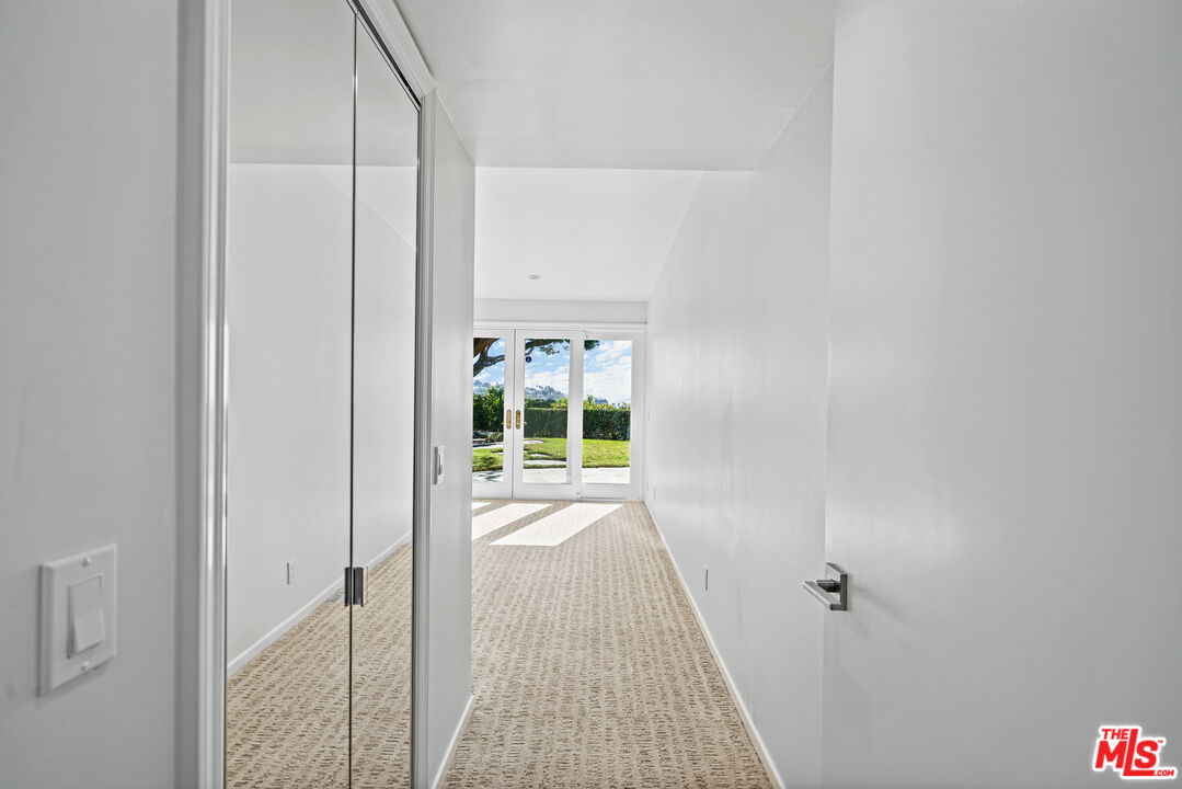 3444 Cloudcroft Drive Malibu, CA 90265 - Photo 21 of 50 a view of a hallway with wooden floor and a bathroom