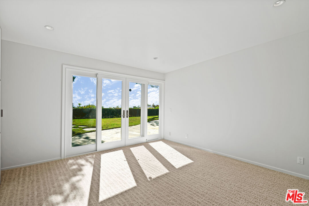 3444 Cloudcroft Drive Malibu, CA 90265 - Photo 22 of 50 a view of empty room with wooden floor and fan