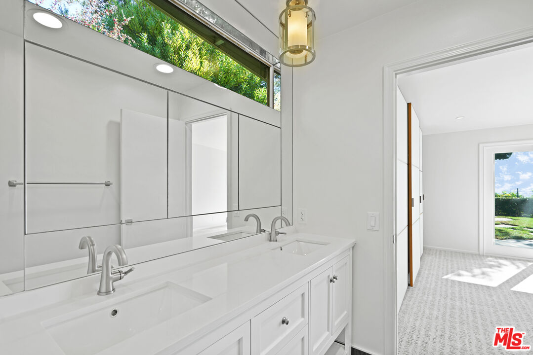 3444 Cloudcroft Drive Malibu, CA 90265 - Photo 24 of 50 a bathroom with a double vanity sink and a mirror