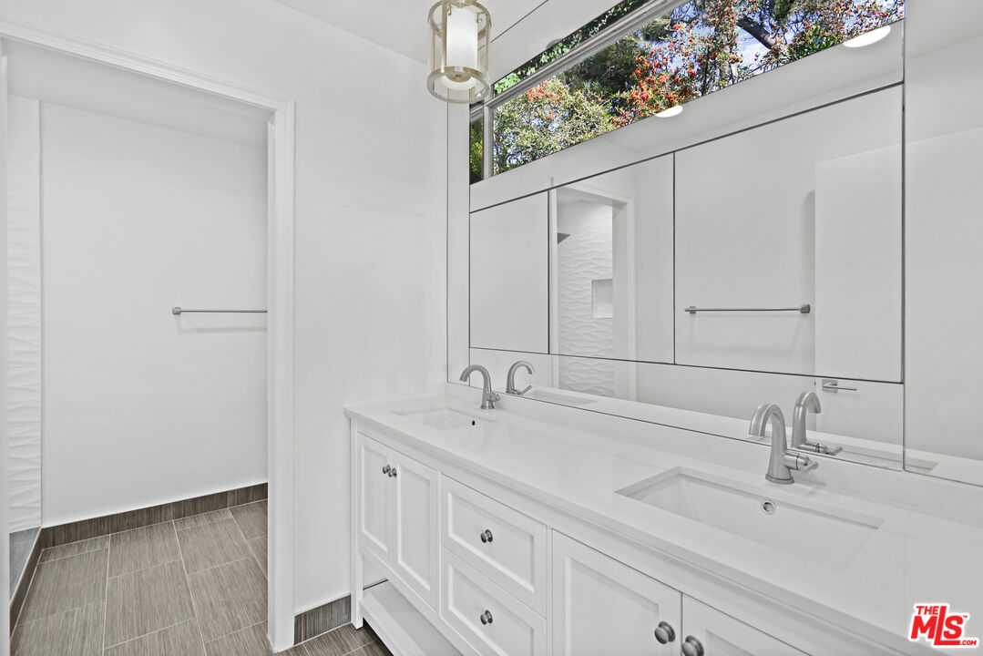 3444 Cloudcroft Drive Malibu, CA 90265 - Photo 26 of 50 a bathroom with a sink and a mirror
