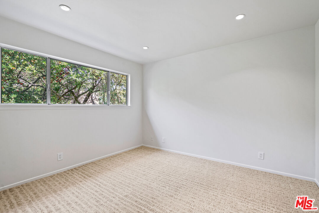 3444 Cloudcroft Drive Malibu, CA 90265 - Photo 30 of 50 an empty room with wooden floor and windows
