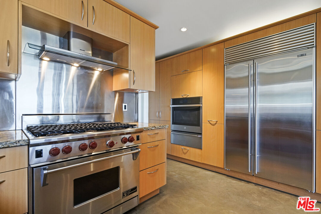 3444 Cloudcroft Drive Malibu, CA 90265 - Photo 3 of 50 a kitchen with stainless steel appliances granite countertop a refrigerator and a stove