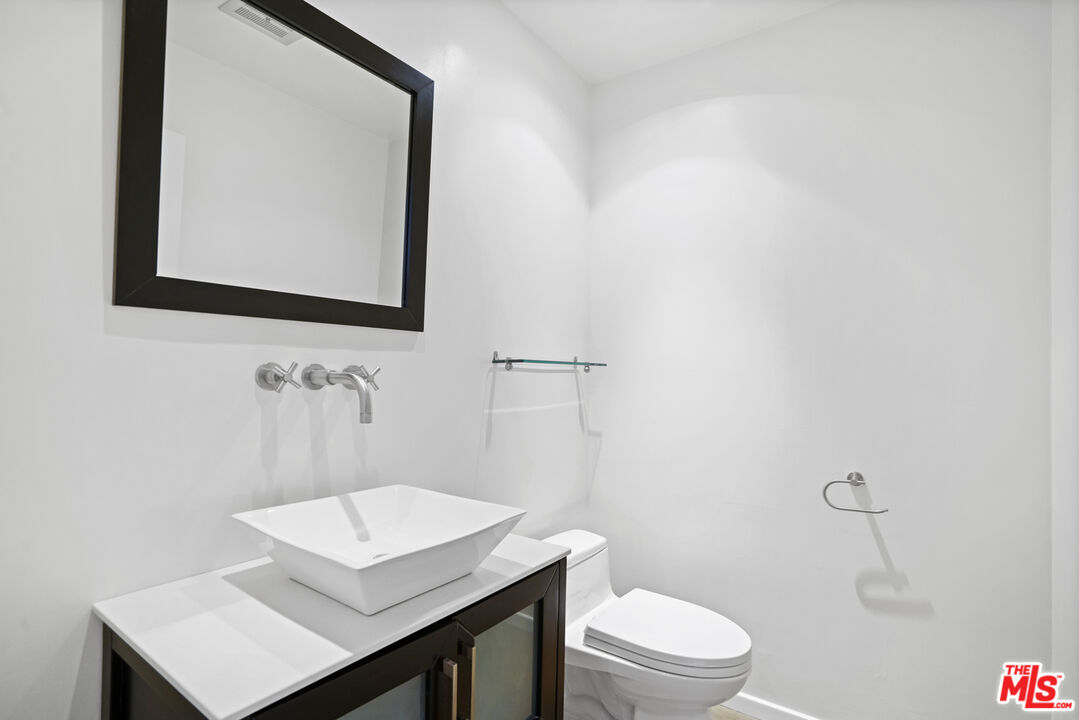 3444 Cloudcroft Drive Malibu, CA 90265 - Photo 8 of 50 a bathroom with a sink a toilet and mirror