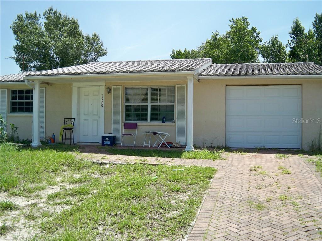 9920 Gray Fox Lane Port Richey, FL 34668 - Photo 1 of 1 a backyard of a house with yard and outdoor seating
