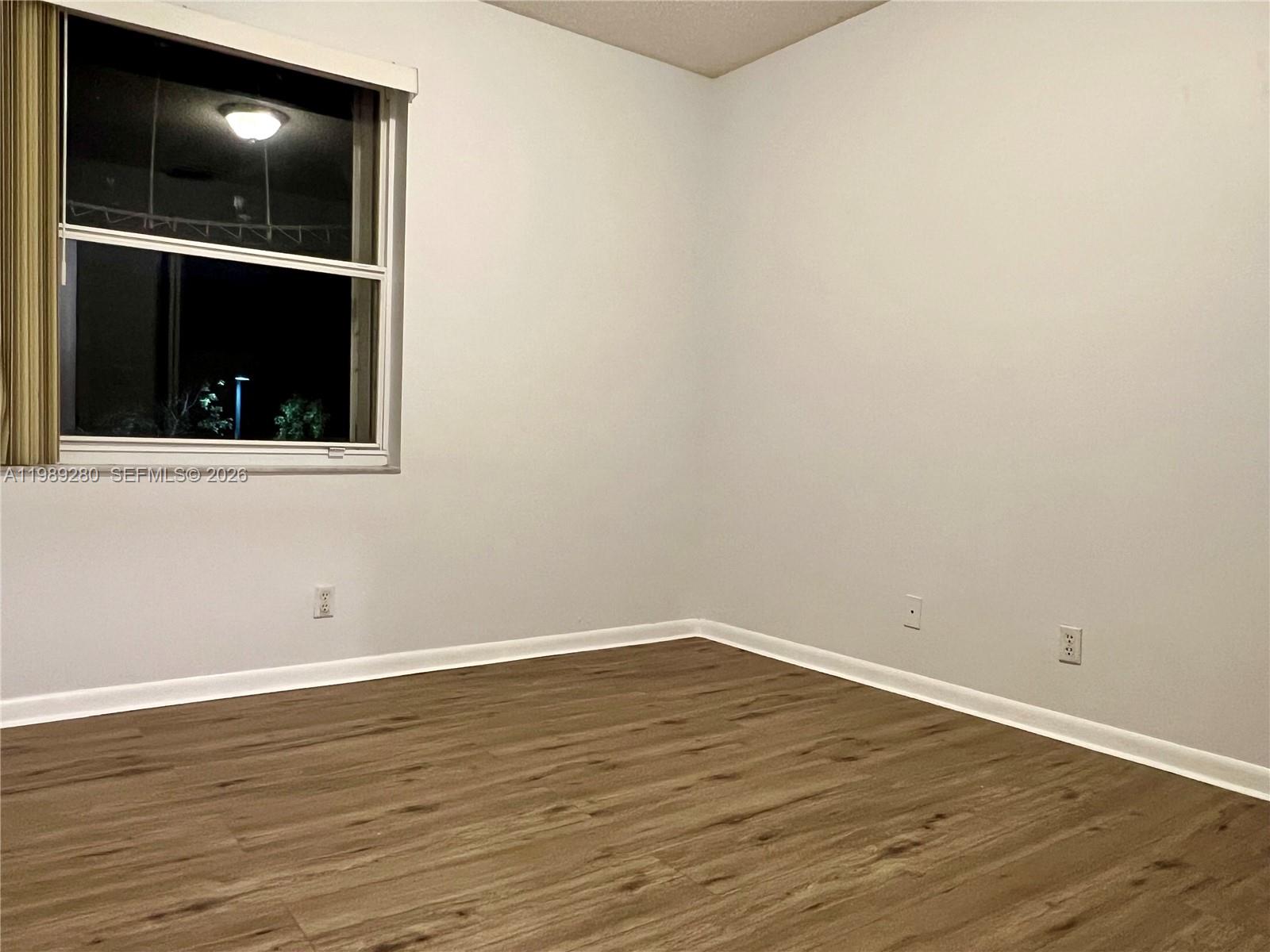 543 Racquet Club Road, Unit 33 Weston, FL 33326 - Photo 23 of 28 wooden floor in an empty room