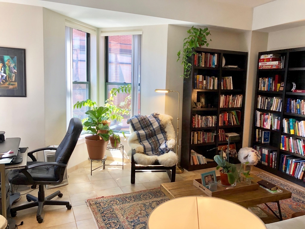 35 Fay Street, Unit 315 Boston, MA 02118 - Photo 3 of 8 a living room with furniture and a book shelf