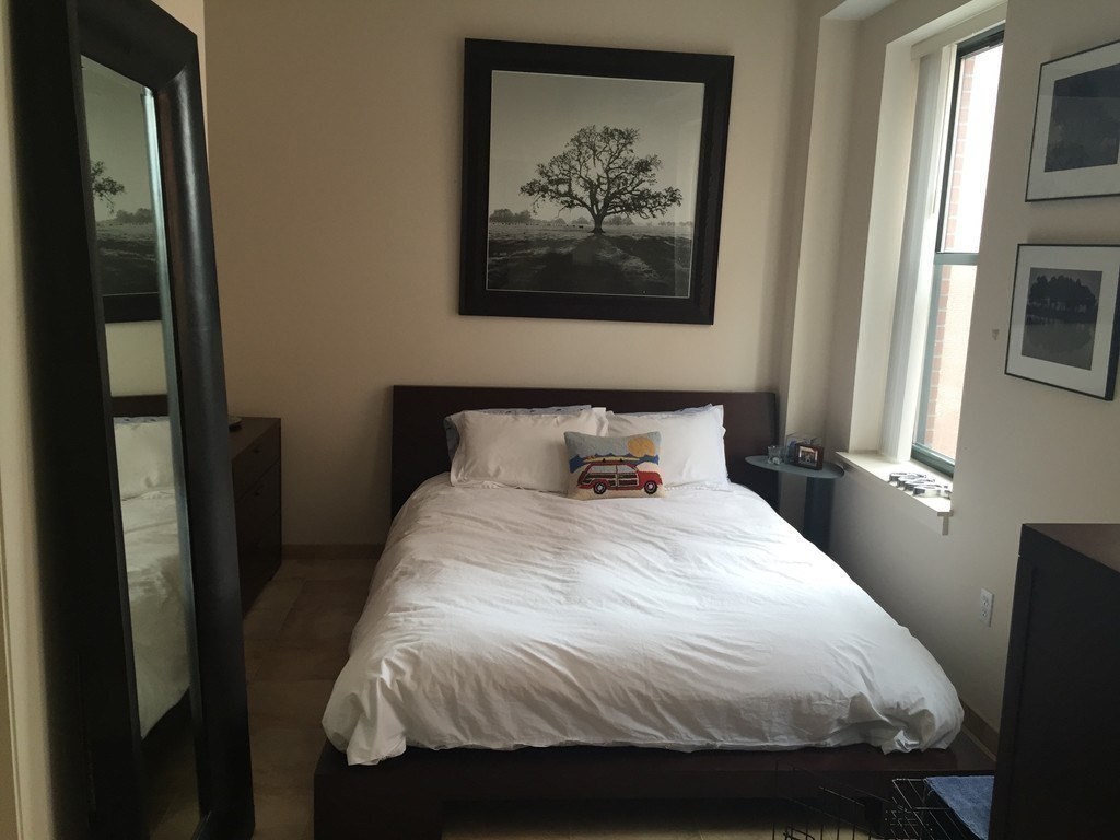 35 Fay Street, Unit 315 Boston, MA 02118 - Photo 5 of 8 a bedroom with a bed and a painting on the wall