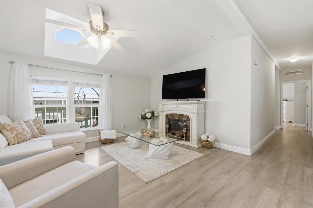 8545 Mission Gorge Road, Unit SPC #147 Santee, CA 92071 - Photo 13 of 43 a living room with furniture a fireplace and a flat screen tv