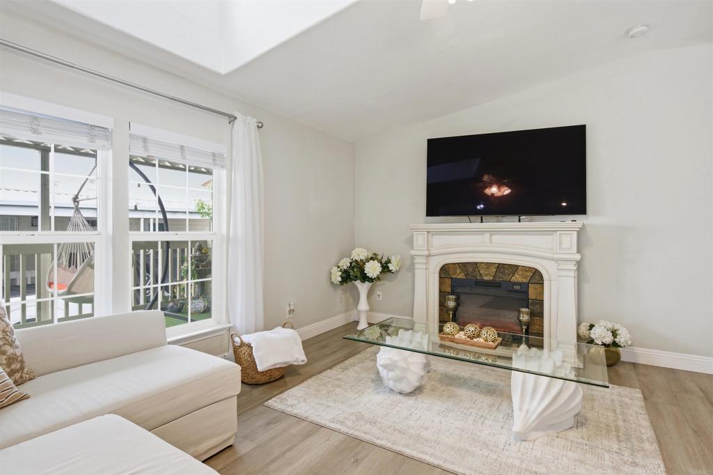 8545 Mission Gorge Road, Unit SPC #147 Santee, CA 92071 - Photo 15 of 43 a living room with furniture a flat screen tv and a fireplace