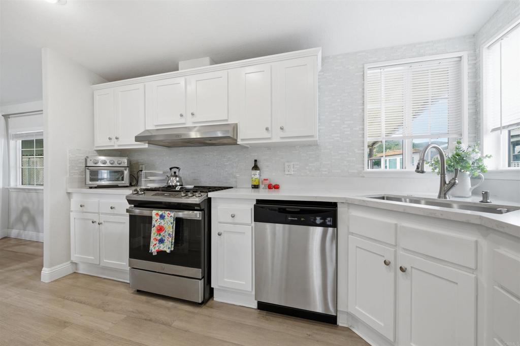 8545 Mission Gorge Road, Unit SPC #147 Santee, CA 92071 - Photo 19 of 43 a kitchen with granite countertop white cabinets and white appliances