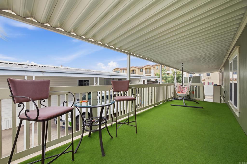 8545 Mission Gorge Road, Unit SPC #147 Santee, CA 92071 - Photo 5 of 43 a view of a chairs and table in the balcony