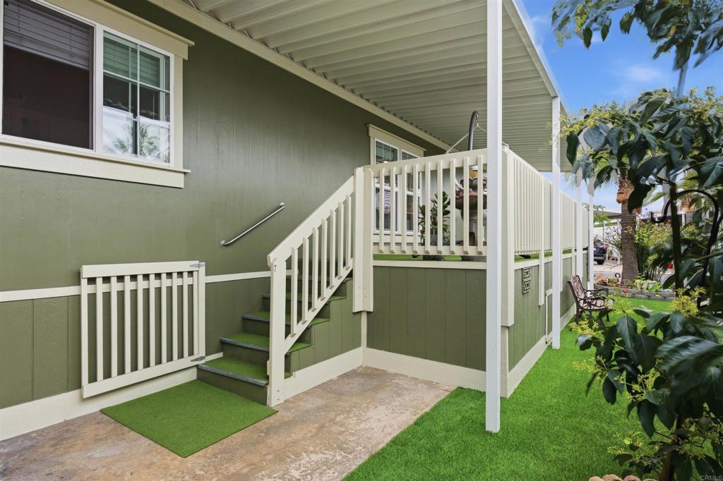 8545 Mission Gorge Road, Unit SPC #147 Santee, CA 92071 - Photo 8 of 43 a view of a house with a small yard and wooden fence