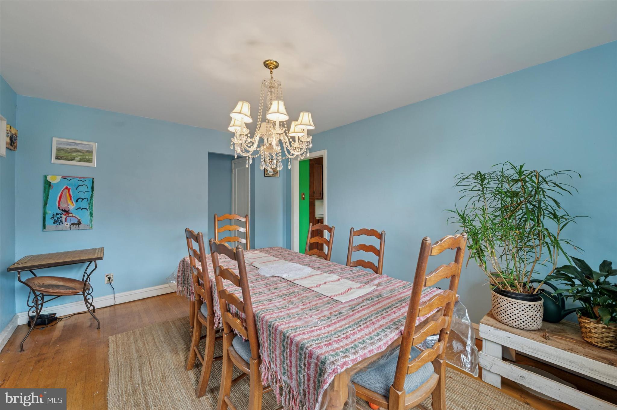 856 North Providence Road Media, PA 19063 - Photo 8 of 25 a dining room with furniture potted plants a chandelier and wooden floor