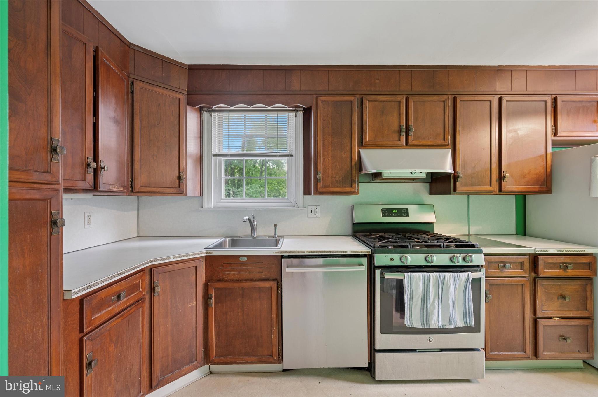 856 North Providence Road Media, PA 19063 - Photo 9 of 25 a kitchen with stainless steel appliances granite countertop a stove a sink and a microwave