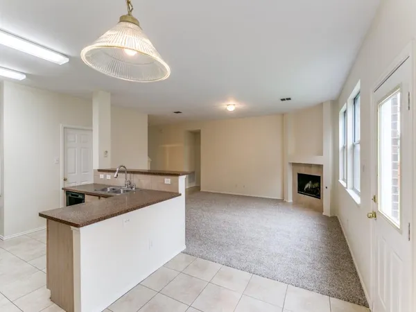 a kitchen with granite countertop a sink and a stove top oven