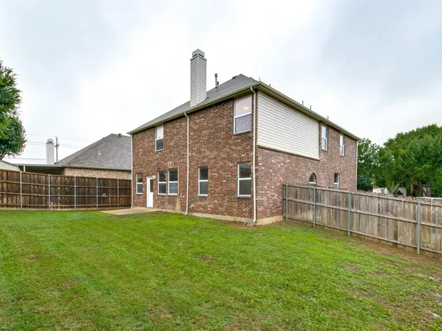 a view of a house with a yard and sitting area