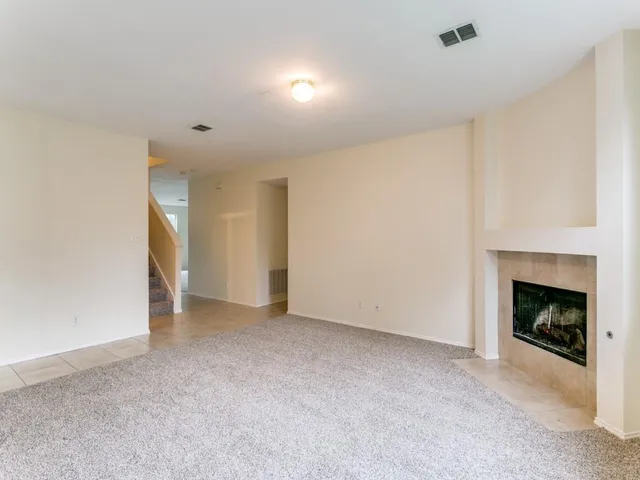a view of empty room with a fireplace