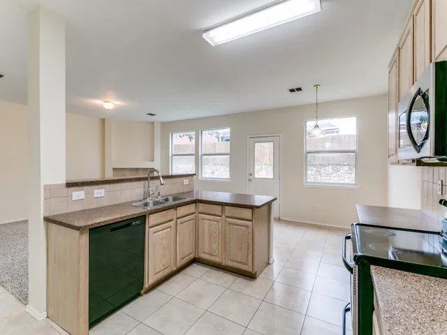 a kitchen with lots of counter top space and window