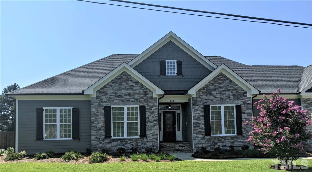 2729 Howard Road Raleigh, NC 27613 - Photo 1 of 26 front view of a house with a yard