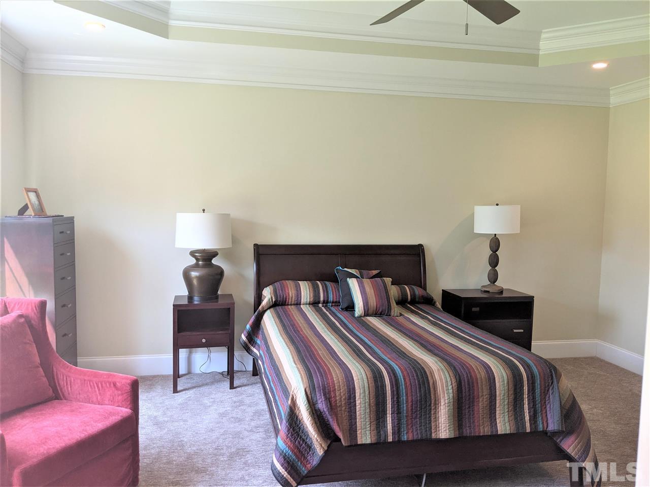 2729 Howard Road Raleigh, NC 27613 - Photo 13 of 26 a bedroom with a bed and a lamp