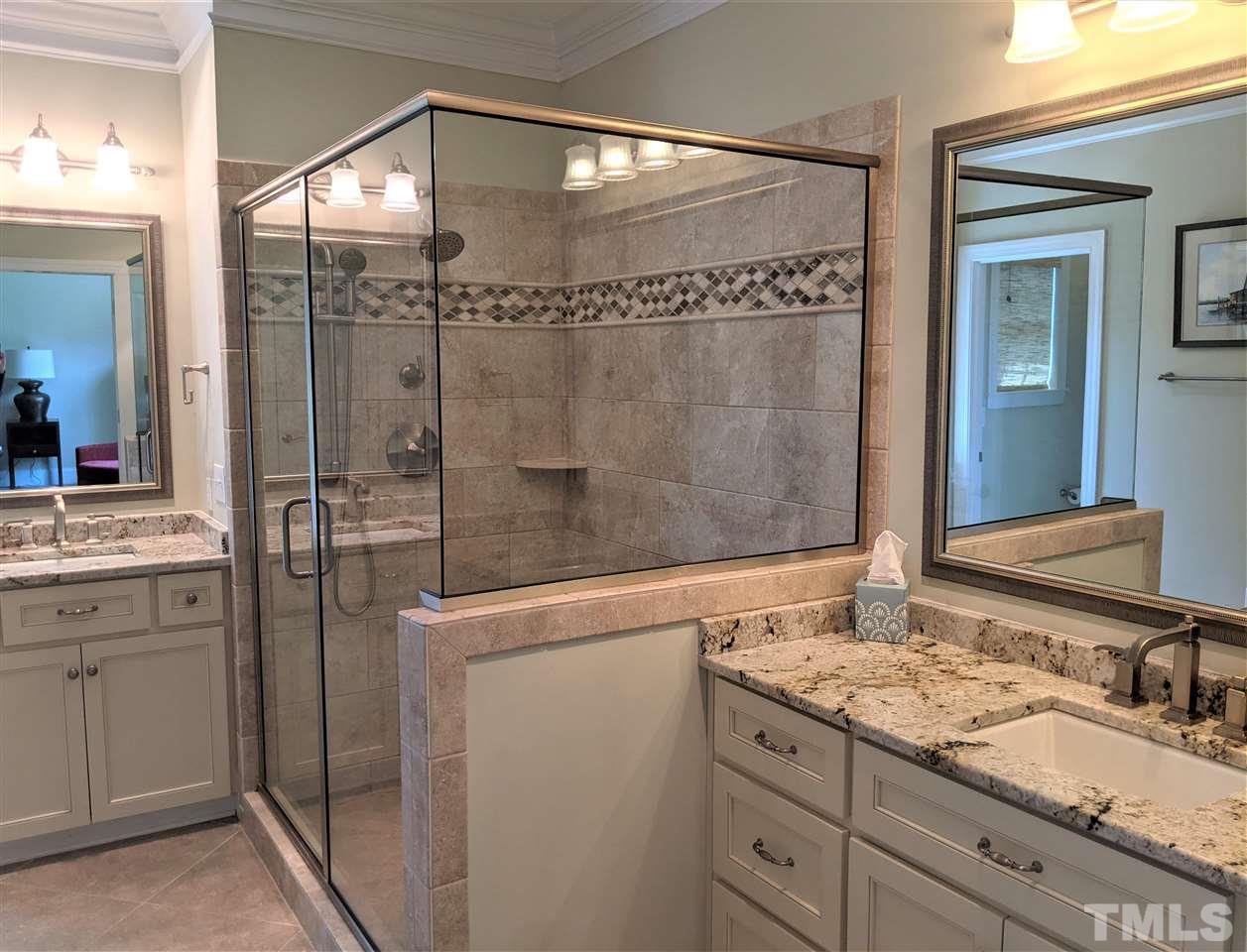 2729 Howard Road Raleigh, NC 27613 - Photo 14 of 26 a bathroom with a granite countertop sink a mirror and shower
