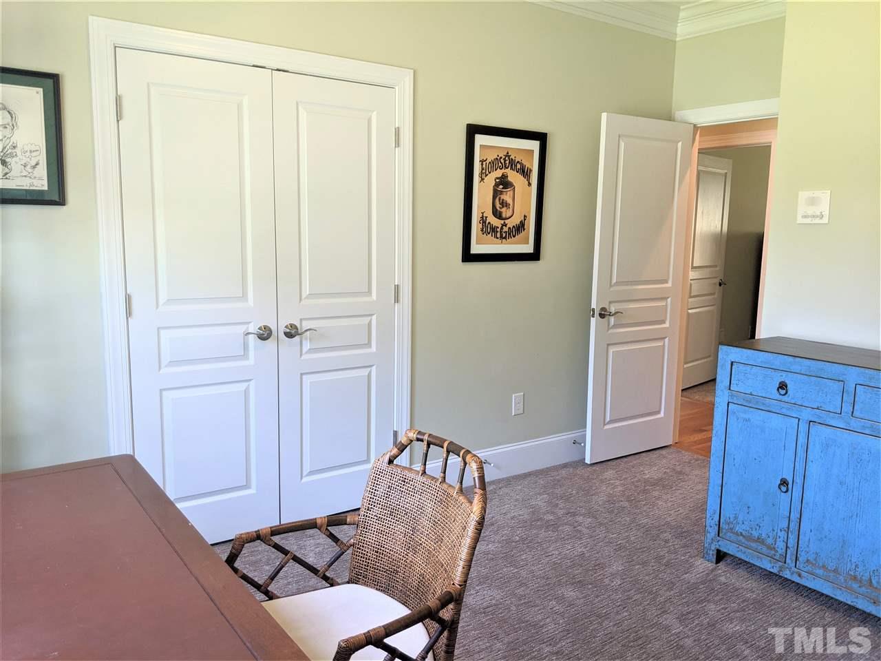 2729 Howard Road Raleigh, NC 27613 - Photo 17 of 26 a view of a bedroom with wooden floor and cabinet