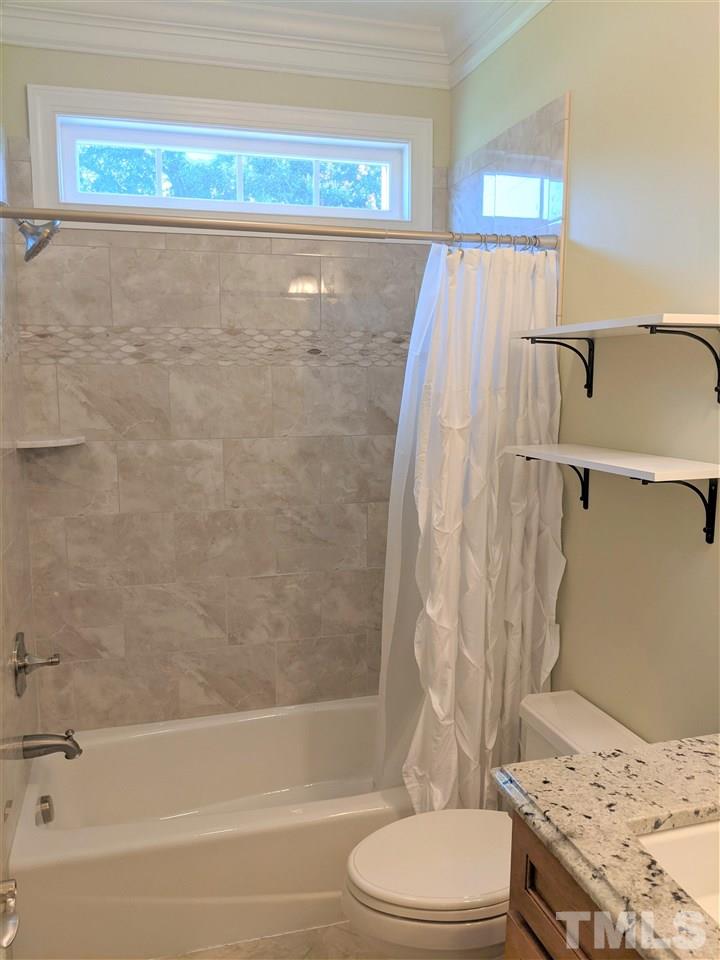 2729 Howard Road Raleigh, NC 27613 - Photo 18 of 26 a bathroom with a sink toilet and shower