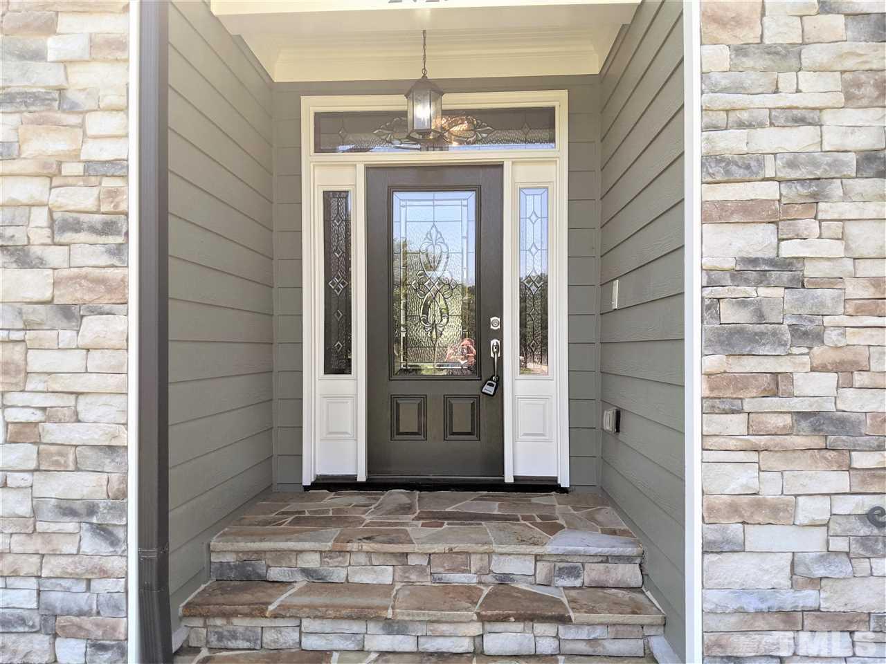 2729 Howard Road Raleigh, NC 27613 - Photo 3 of 26 a view of a entryway door with brick walls