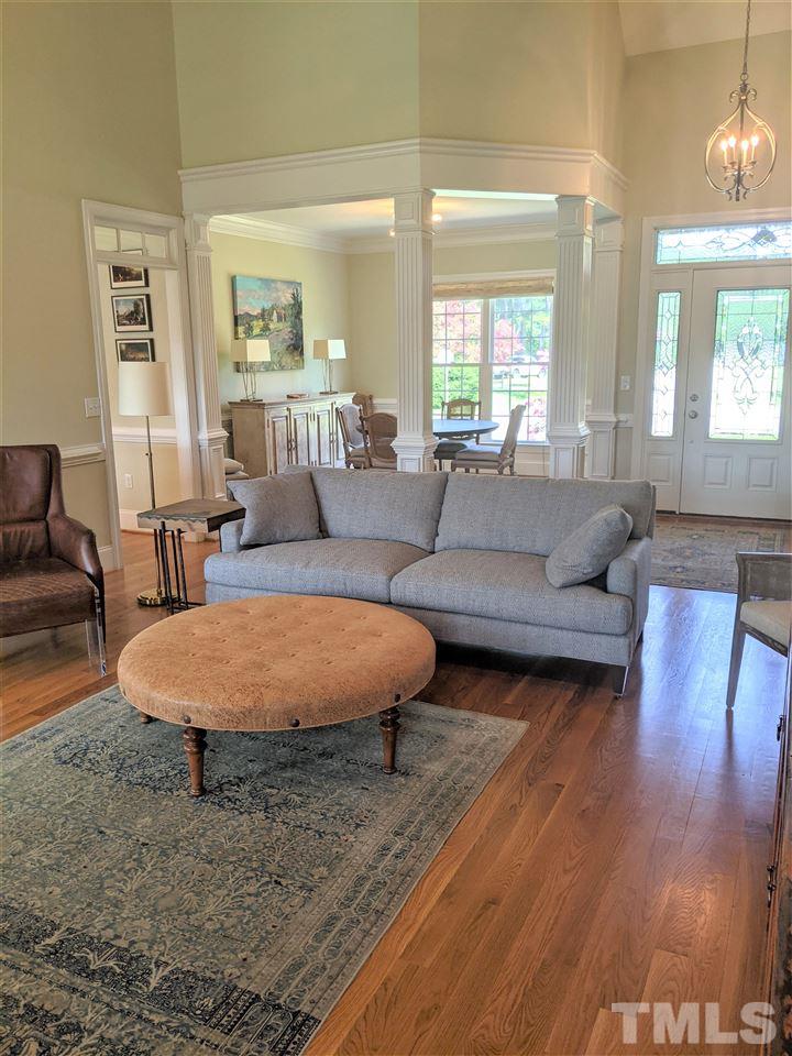 2729 Howard Road Raleigh, NC 27613 - Photo 10 of 26 a living room with furniture a wooden floor and a large window