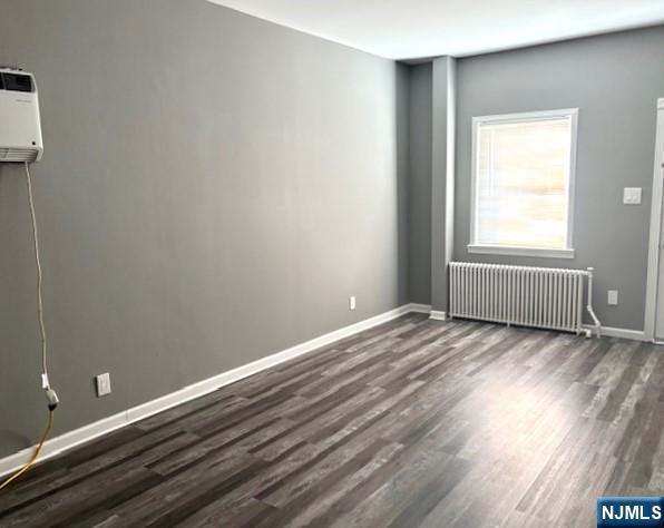 291 Delano Place, Unit 1 Fairview, NJ 07022 - Photo 2 of 7 an empty room with wooden floor and windows