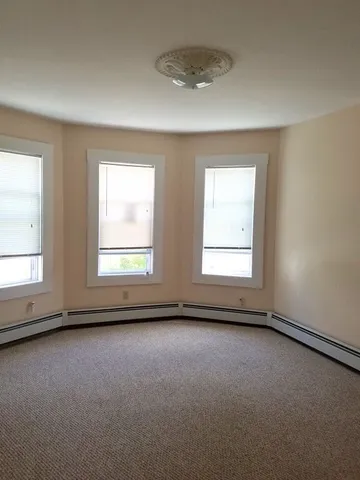 an empty room with a empty space and windows