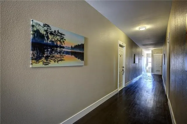 a view of a hallway with wooden floor