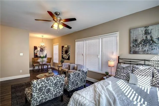 a bedroom with bed and balcony view