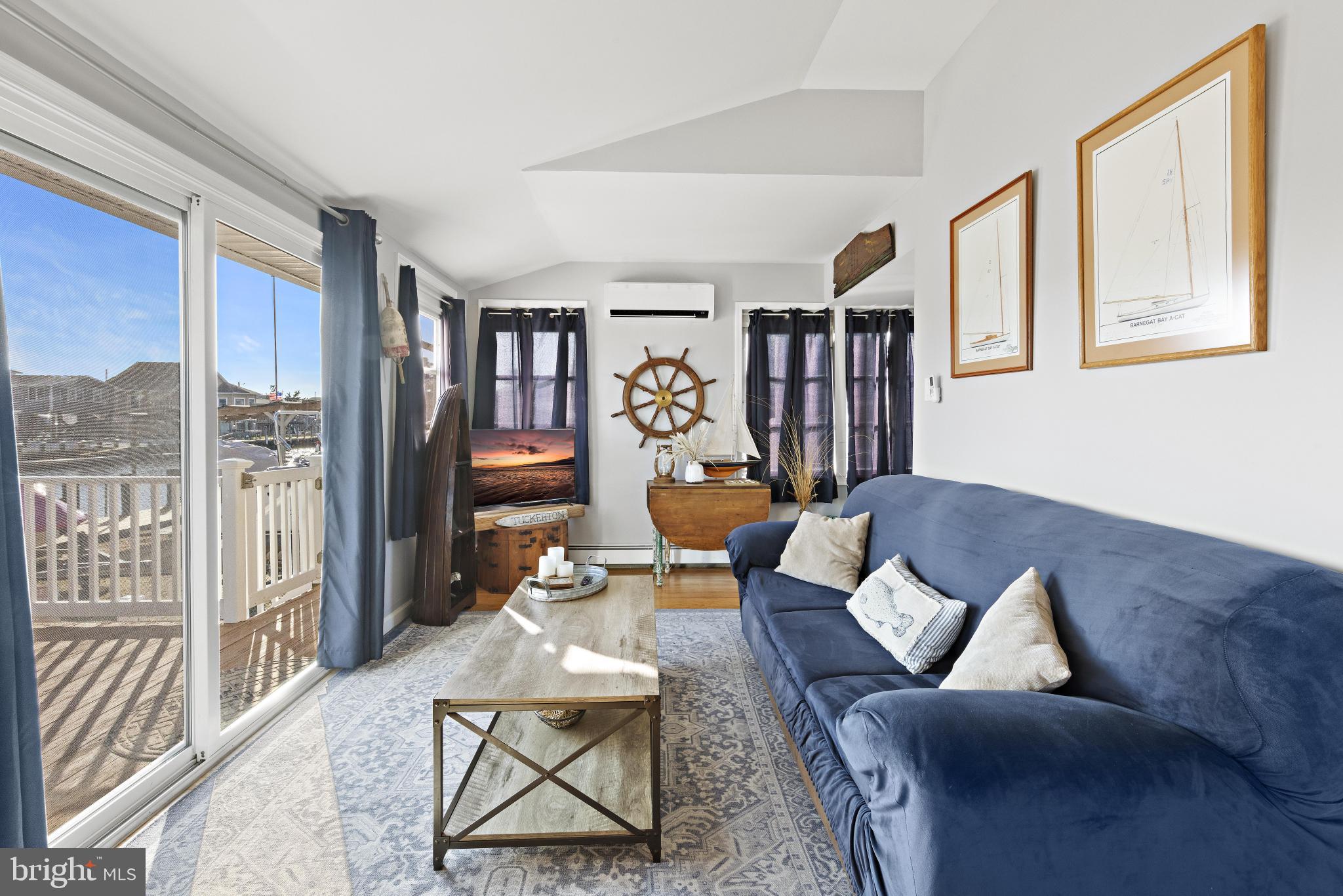 79 Dolphin Road Tuckerton, NJ 08087 - Photo 11 of 53 a living room with furniture a rug and a bookshelf