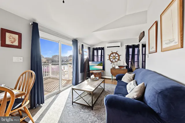 a living room with furniture and a floor to ceiling window