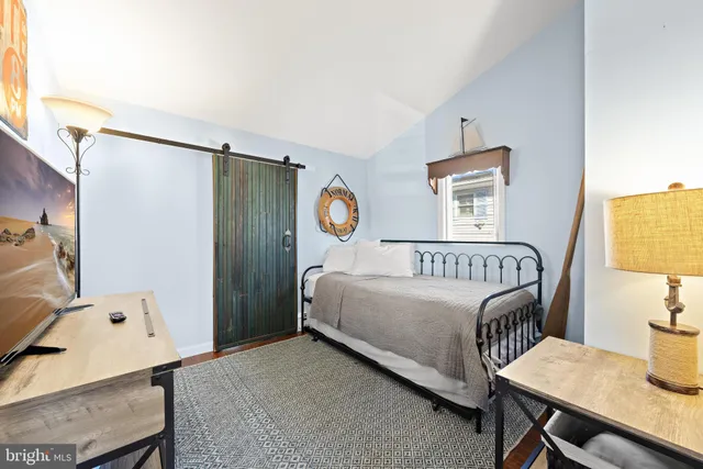 a bedroom with a bed and a table in it