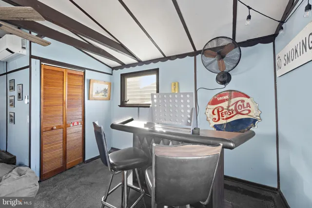 a utility room with dryer washer and a view of living room