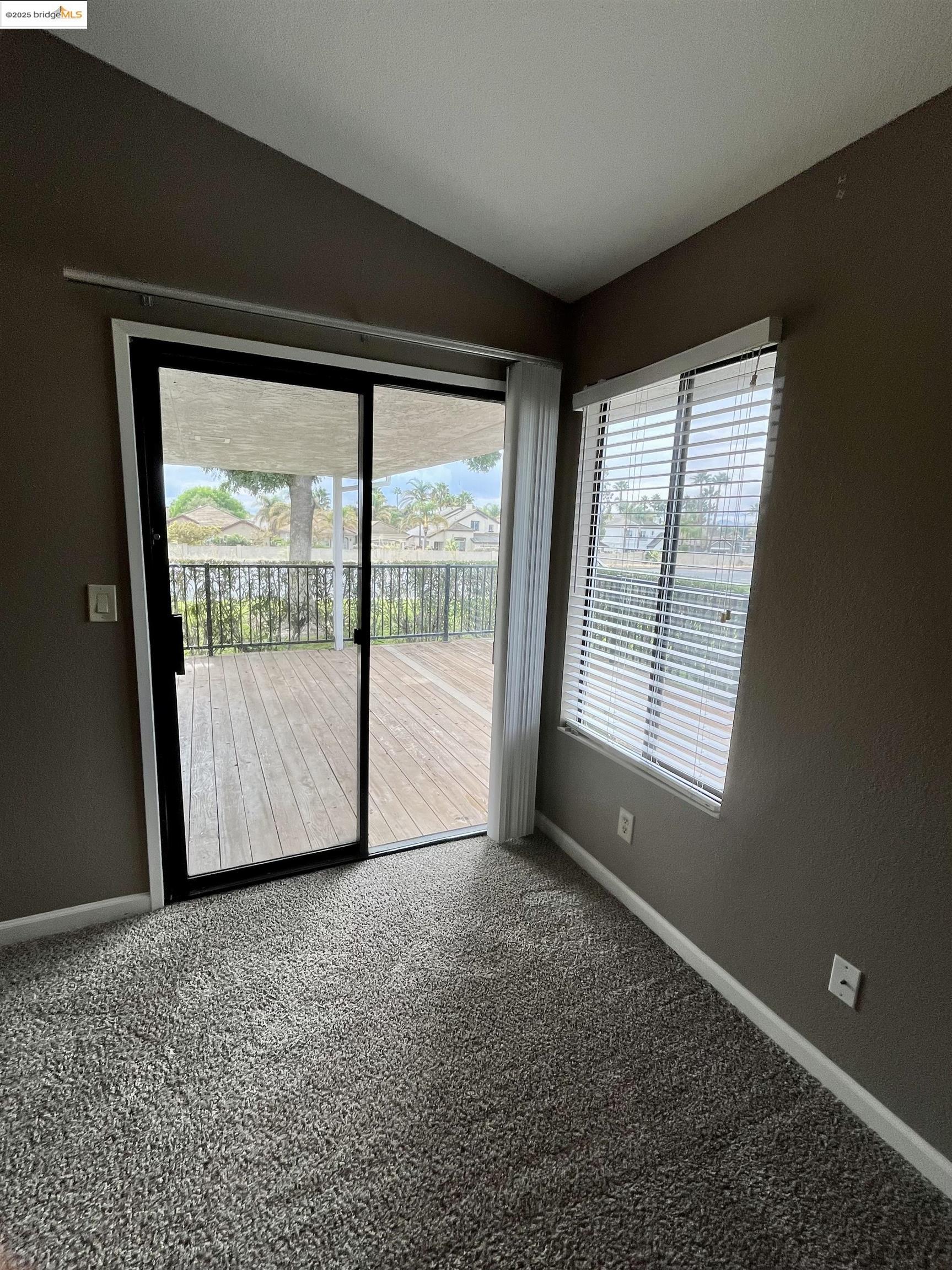 5796 Cutter Loop Discovery Bay, CA 94505 - Photo 15 of 29 a view of an empty room with wooden floor and a window