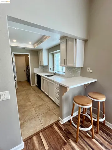 a kitchen with a stove a sink and a refrigerator