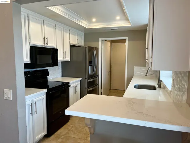 a kitchen with stainless steel appliances a refrigerator stove microwave and sink