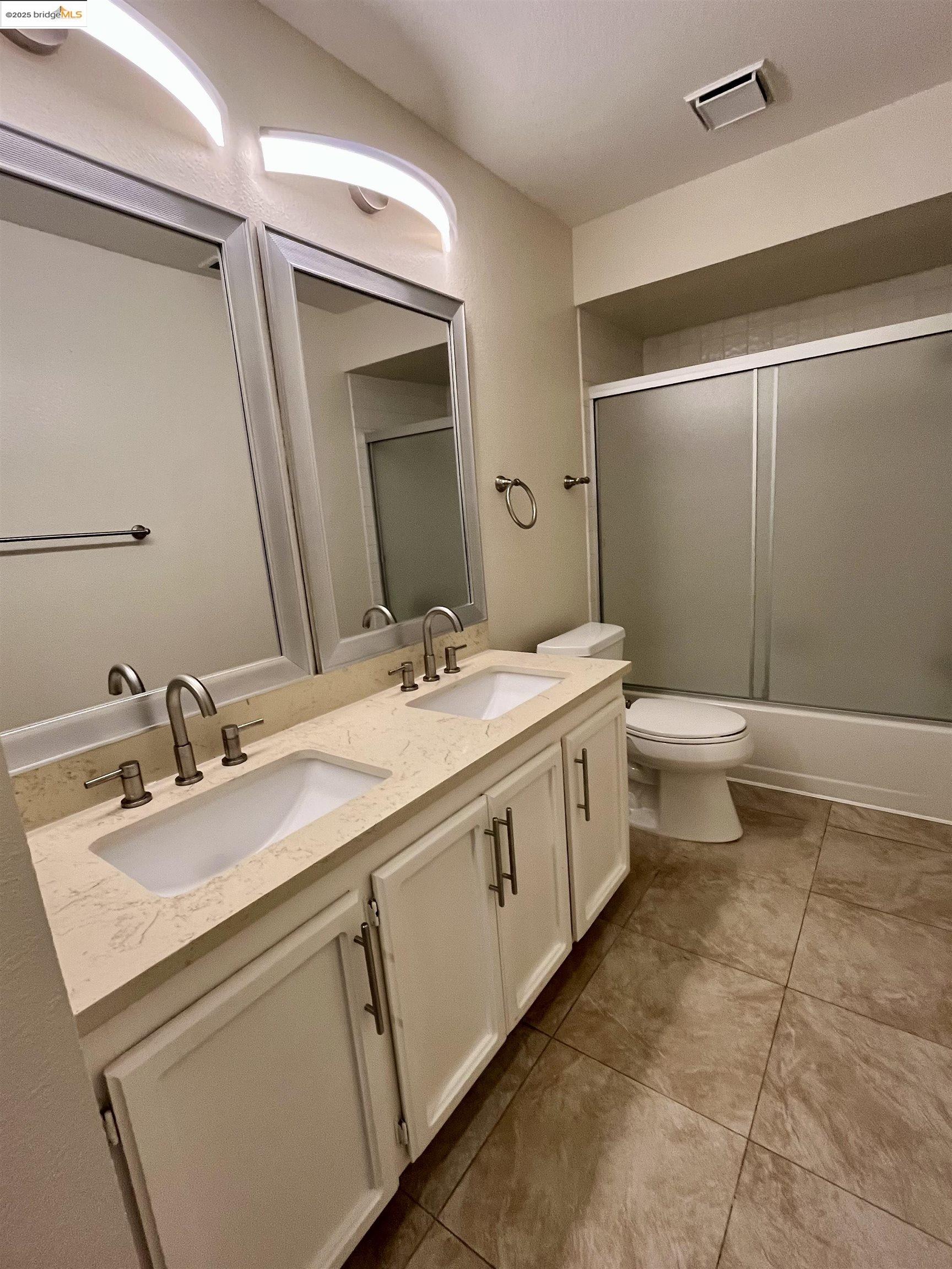 5796 Cutter Loop Discovery Bay, CA 94505 - Photo 21 of 29 a bathroom with a double vanity sink mirror and toilet